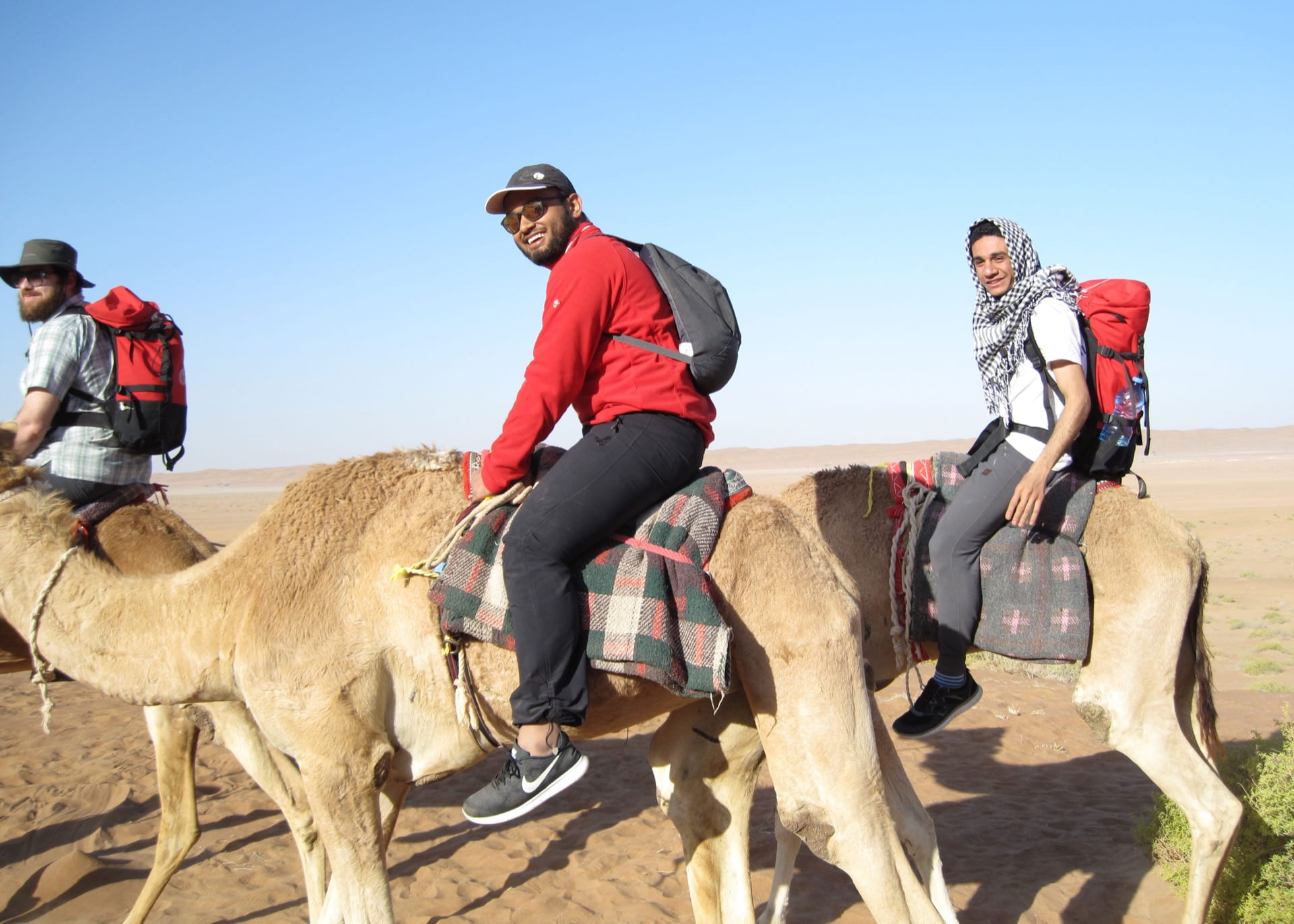 Students riding camels.