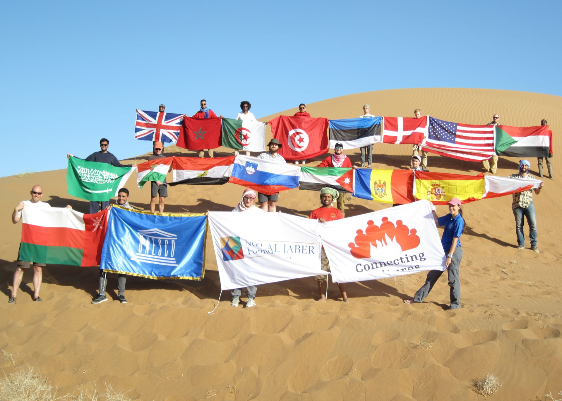 Students holding flags from around the world