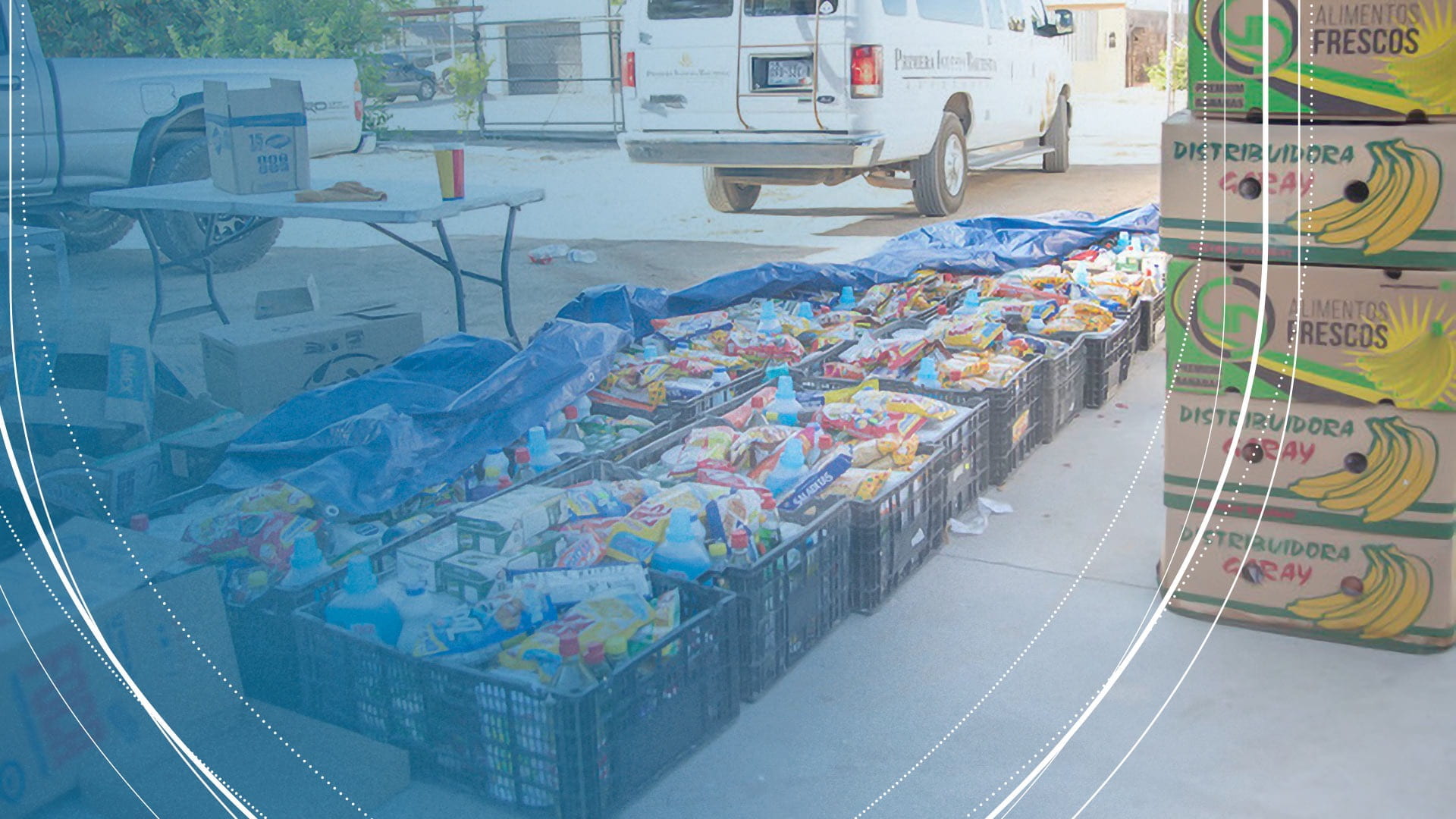 A shipment of food and cleaning supplies on pavement behind a van in San Luis Rio Colorado, Mexico