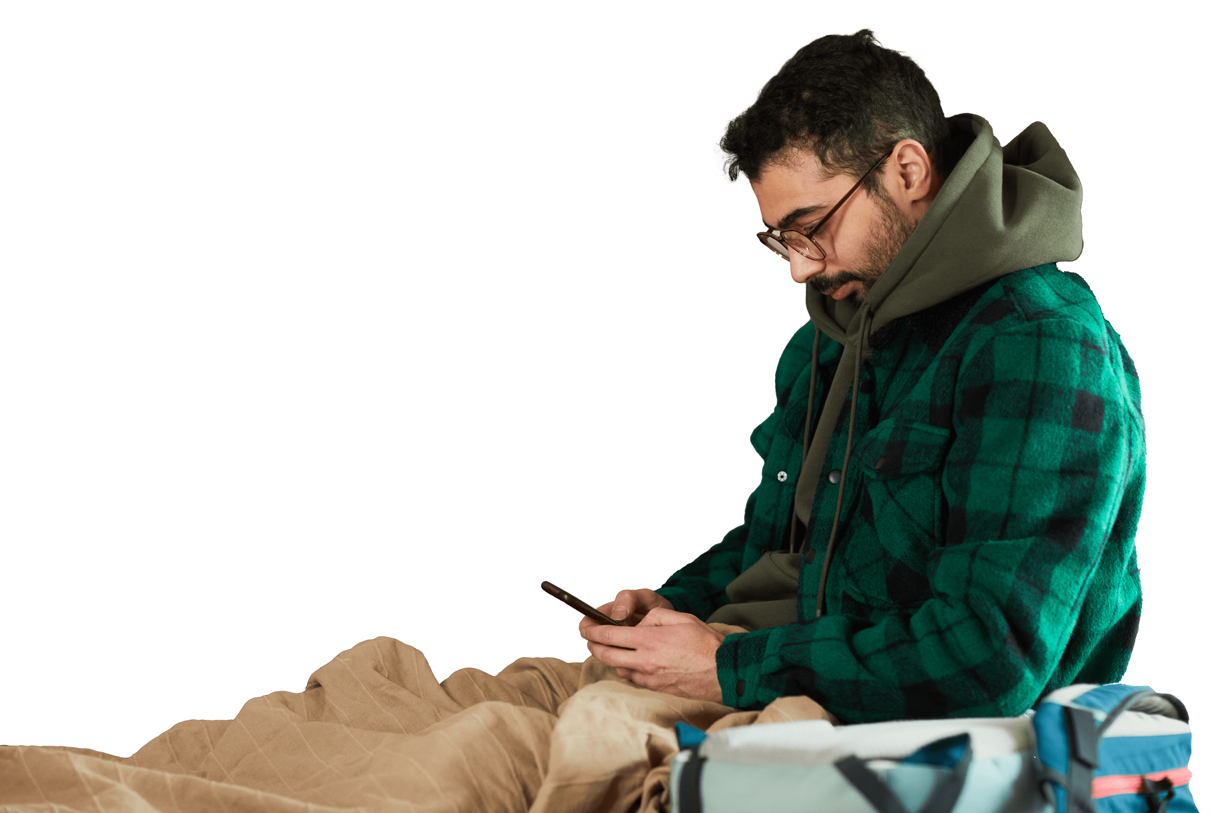 Homeless person using a cellphone in a shelter.